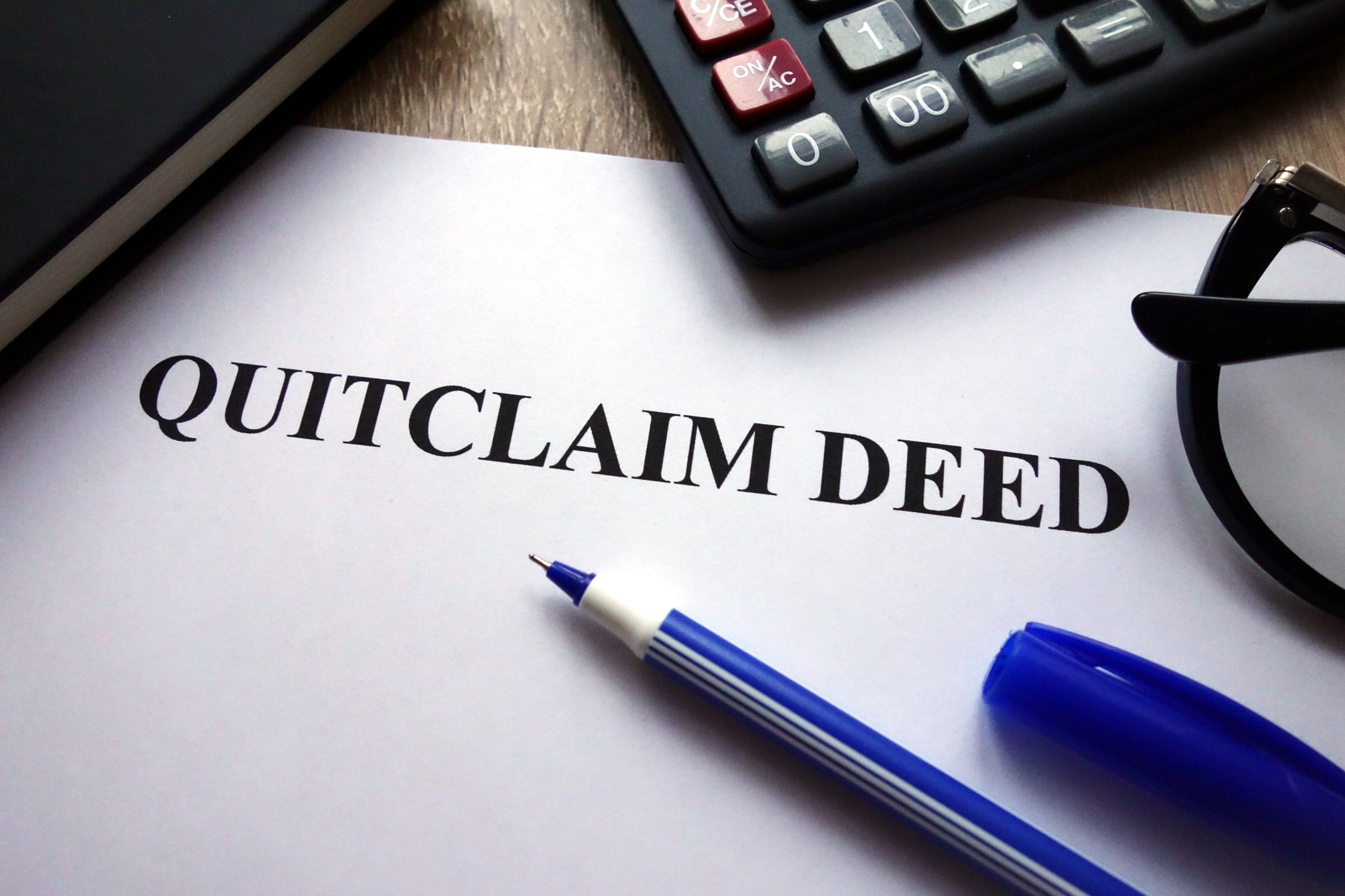 Quitclaim deed typed on a piece of paper on desk