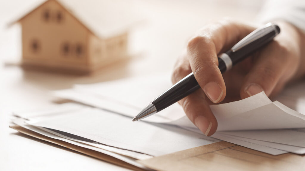 First-time homebuyer reviewing closing cost and property tax documents.